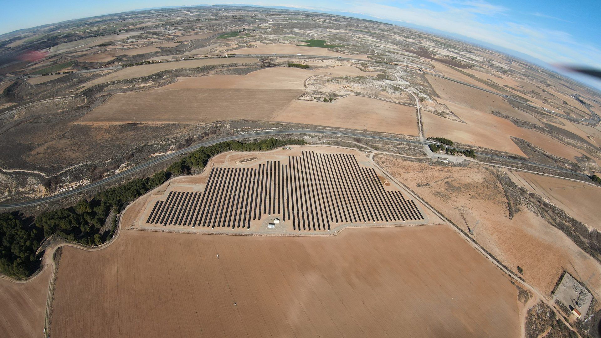 Wide aerial view of the Candasnos PV plant among farmland