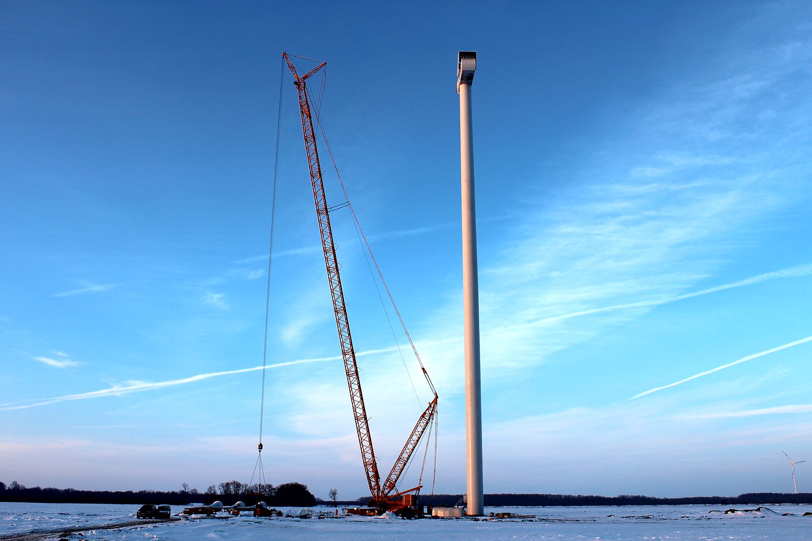 Crawler crane beside the Balchik Wind III tower in snow