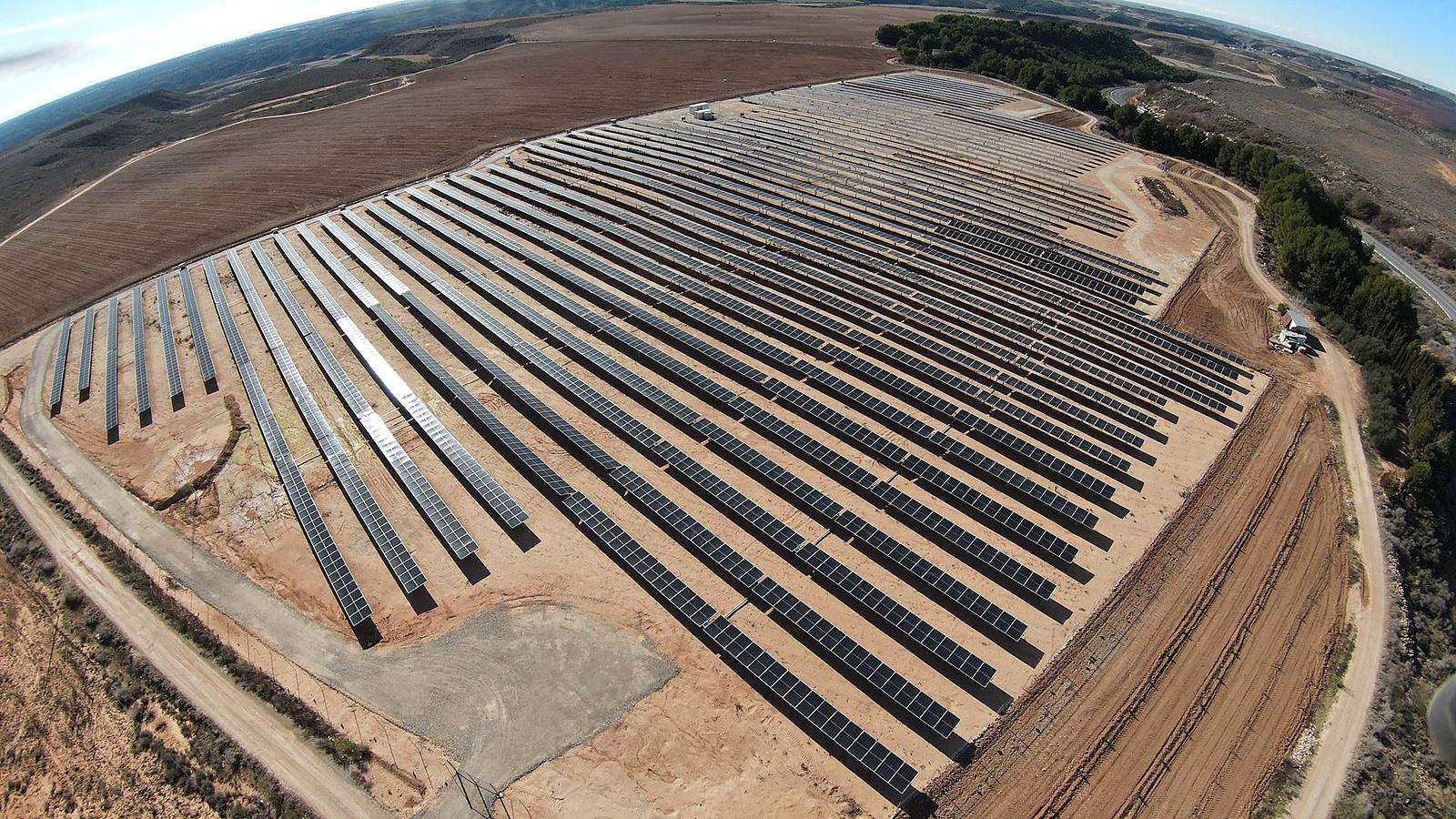 Rows of solar modules at the Candasnos plant seen from a drone