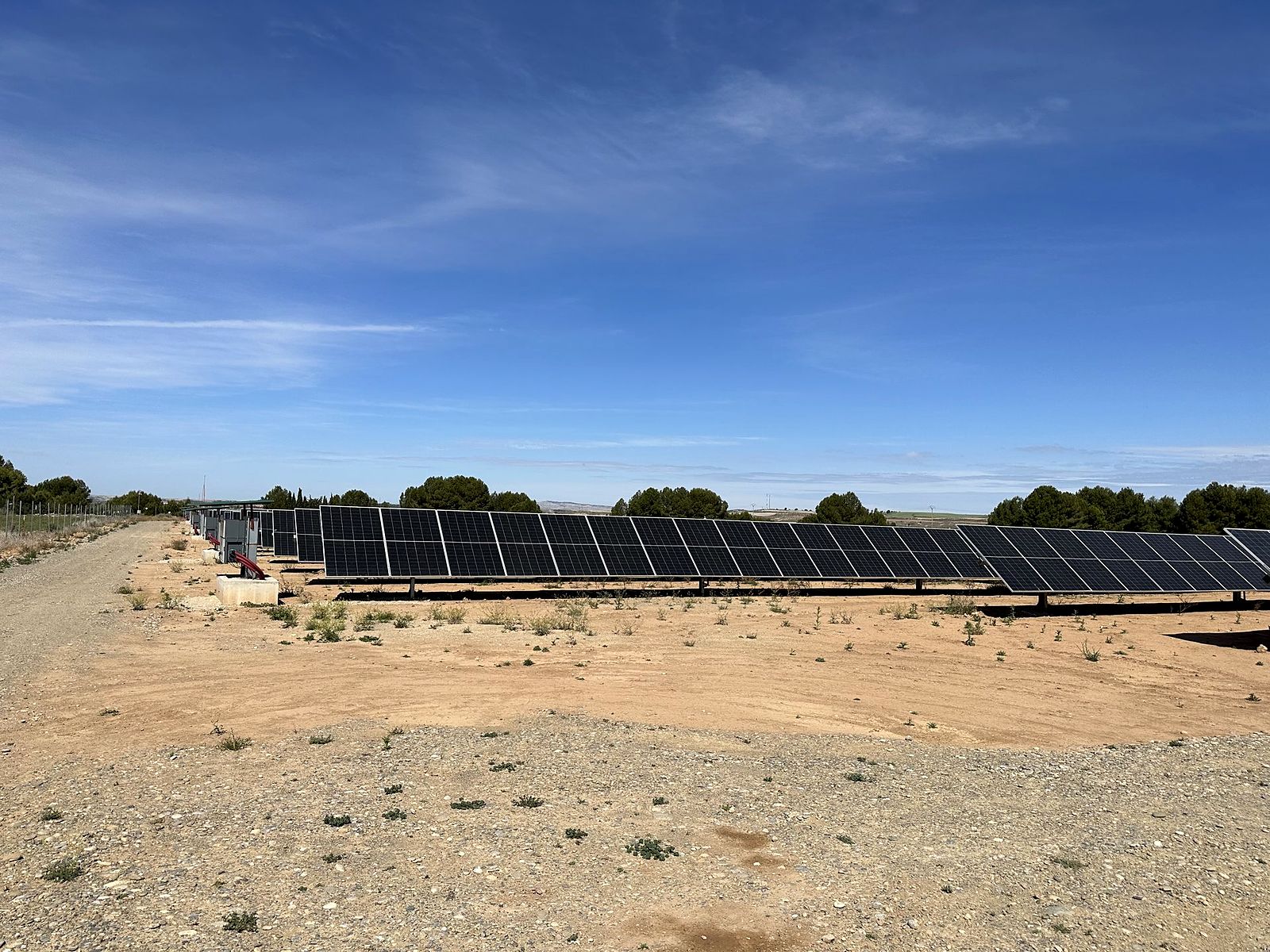 Solar module rows at Candasnos under a blue sky