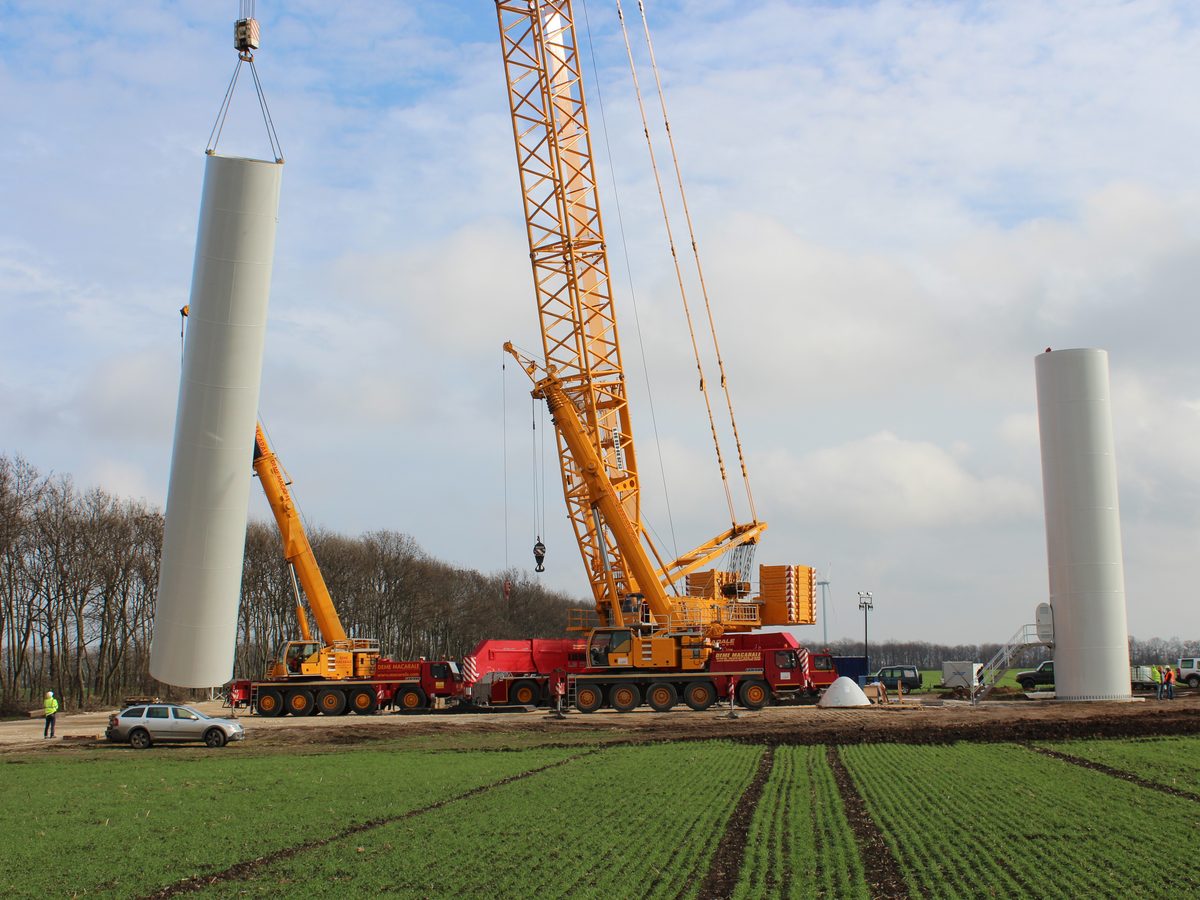 Tower sections being lifted by mobile cranes during construction of Balchik Wind II